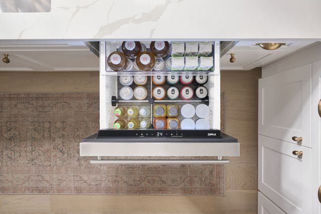top view of an opened refrigerator drawer full of drinks