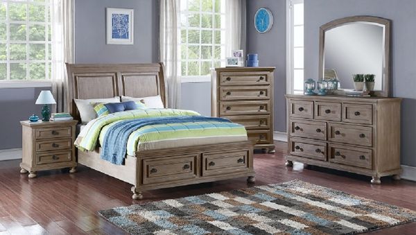View of a casual teen bedroom with a full-size bedroom set, grey walls, and a blue and green comforter with accents.
