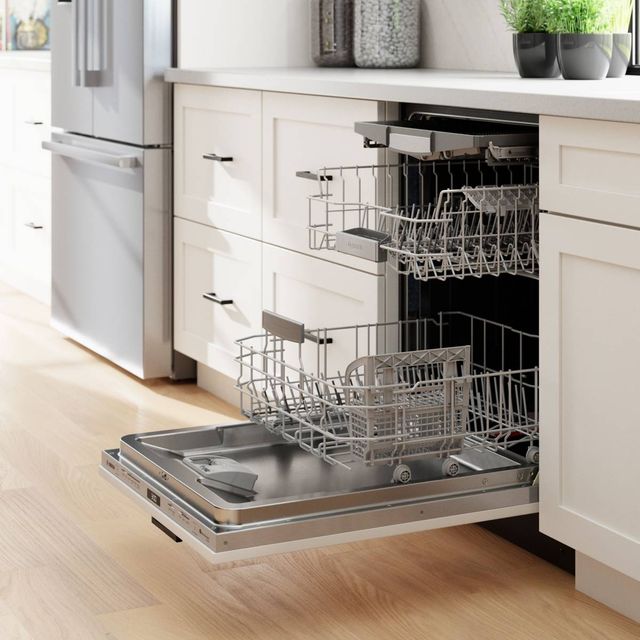 Front view of an opened Bosch panel ready dishwasher in a modern kitchen