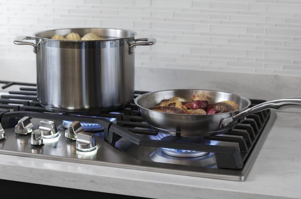 Modern gas stove top with illuminated safety knobs