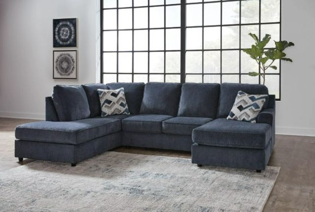 front view of a navy blue small u-shaped sectional in a modern living room