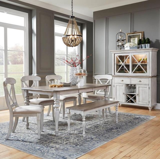 front view of a modern dining room with a whitewashed wooden hutch with lighting inside