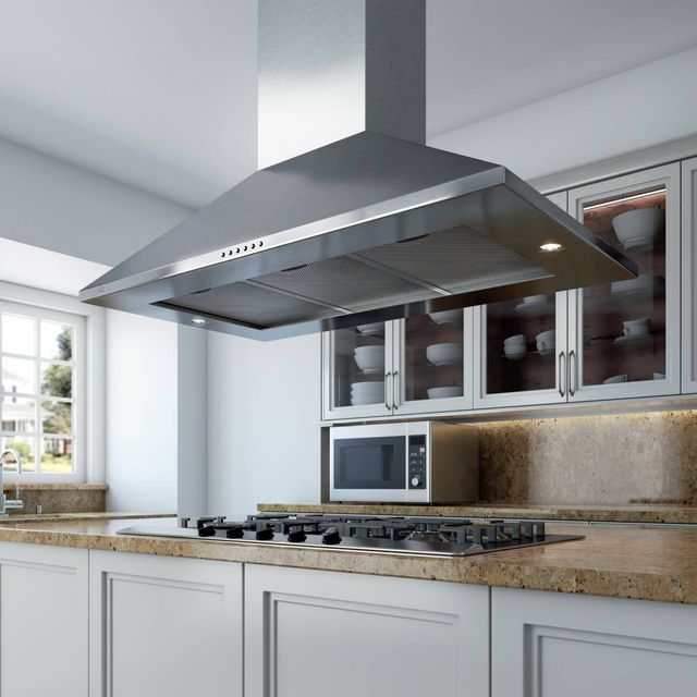 Front view of a modern kitchen with a XO vent hood and rangetop below