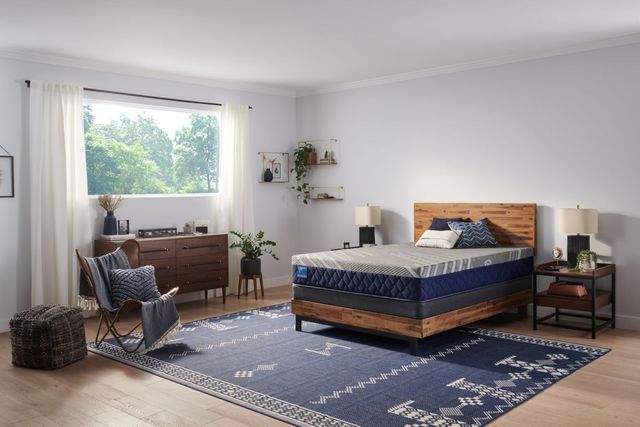 Woman making bed with hybrid mattress Woman making bed with hybrid mattress