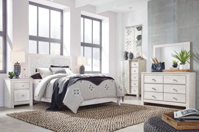 Front view of a casual bedroom with a white queen bedroom set