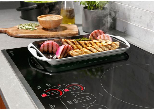 Credit: GE Profile Close view of a pan of food being heated on an induction cooktop