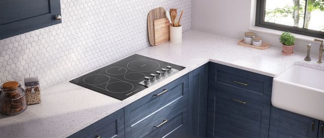 Front view of a modern kitchen with a Frigidaire electric cooktop