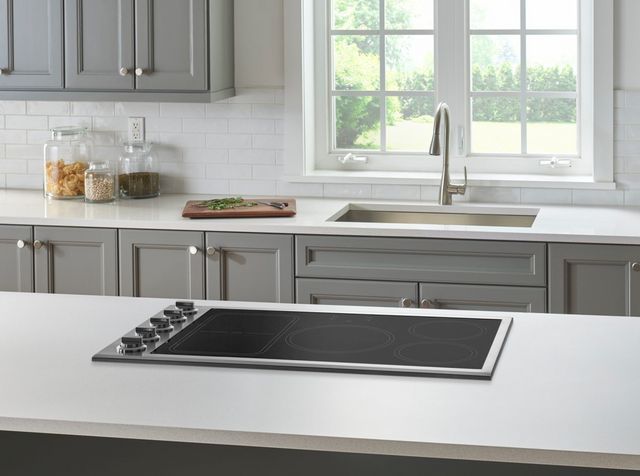 Front view of a modern kitchen with a 36" induction cooktop with knobs from Bluestar