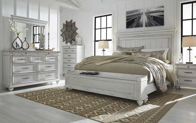 front view of a modern farmhouse bedroom with a white wooden king side bed and bedroom set