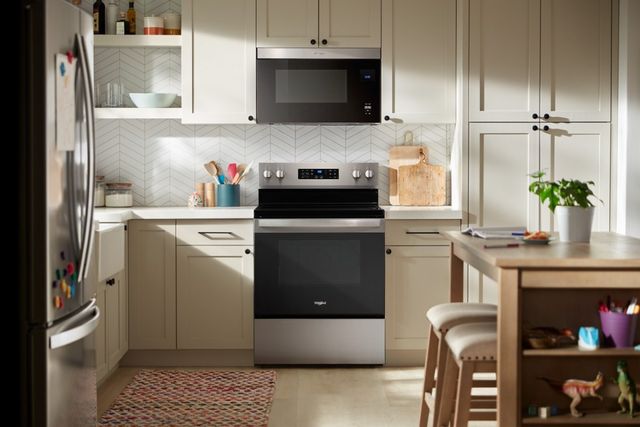 Front view of a modern kitchen with a Whirlpool electric range