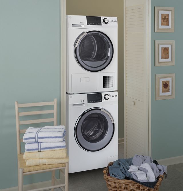 Front view of a white GE stacked washer and dryer in a closet