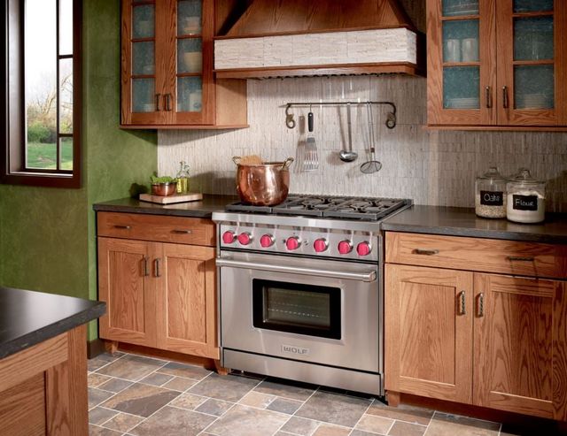Front view of a Wolf 36" gas range in a modern rustic kitchen
