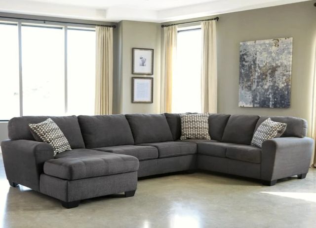 Front view of a modern living room with the Benchcraft® Ambee 3-Piece Slate Left-Arm Facing Sectional and Chaise