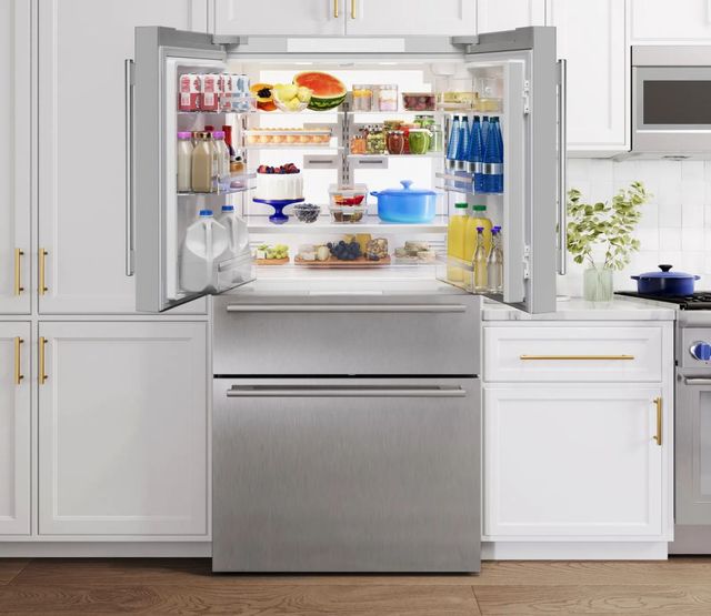 Front view of an opened Thermador counter depth french door refrigerator in a modern kitchen