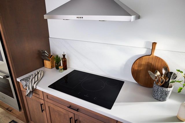 Induction vs Electric Cooktop in modern kitchen Induction vs Electric Cooktop in modern kitchen