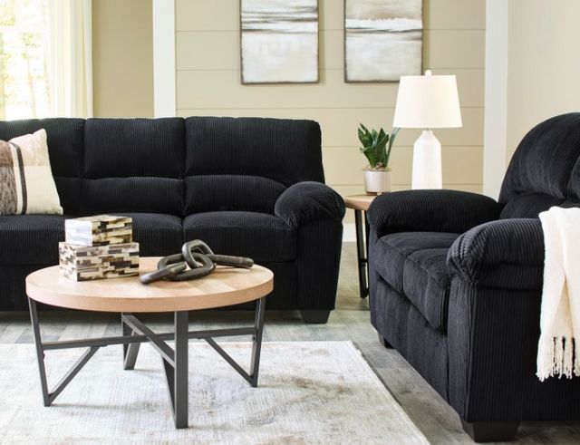 front view of the Signature Design by Ashley® SimpleJoy Onyx Sofa in a modern living room