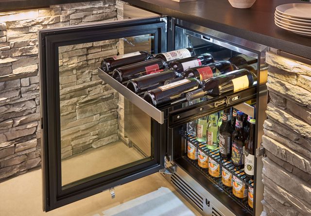 Front view of an opened outdoor built in wine cabinet with the top drawer pulled out