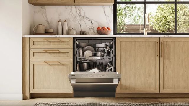 Credit: Bosch Front view of a modern kitchen with a slightly opened Bosch dishwasher