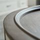 Bassett® Furniture Bella Warm Gray Round Cocktail Table with Aged Whitestone Base-3