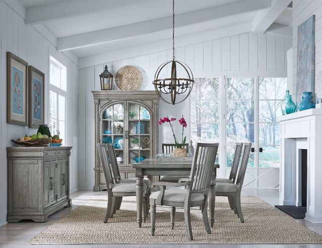 front view of a modern dining room with white walls, grey wooden furniture including a dining table with six chairs, a sideboard, and a hutch