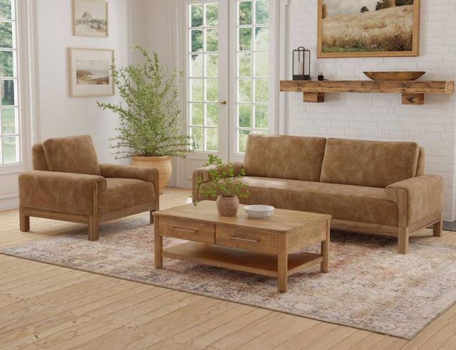 front view of an earthy style living room with a camel colored sofa and chairs with light wooden and green accents
