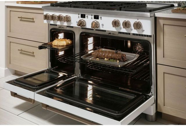 front view of an opened white double oven range