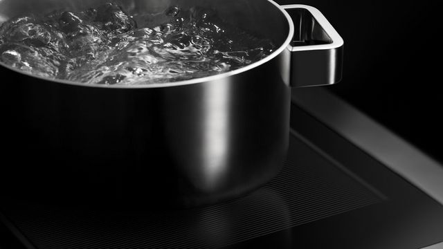 Close view of a pot of water boiling on an induction range
