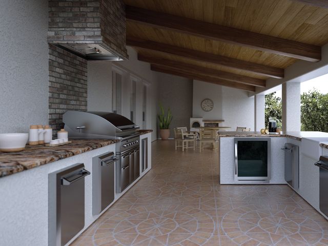 Front view of a covered outdoor kitchen with a built in grill and range hood.