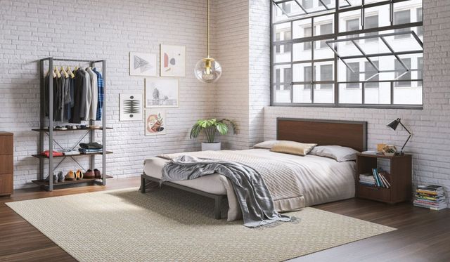 view of a modern bedroom with a white brick wall and a panel bed with a matching nightstand