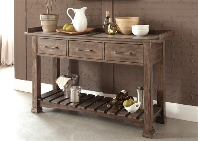front view of a wooden buffet table against a brown brick wall