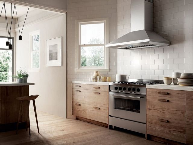 Credit: Elica View of a luxury kitchen with a 36" gas range and a wall mounted range hood above it