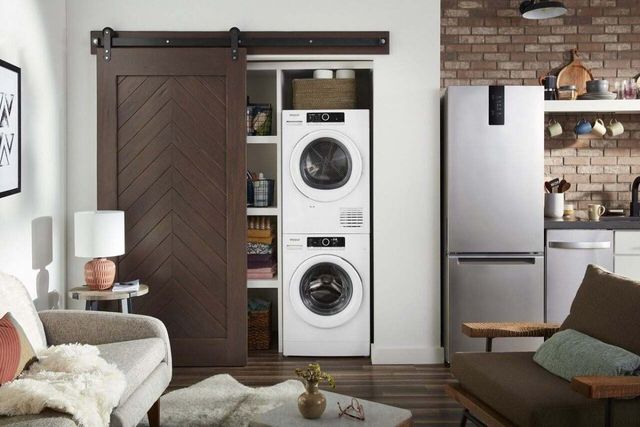 Front view of a stacked washer and ventless dryer in a laundry closet