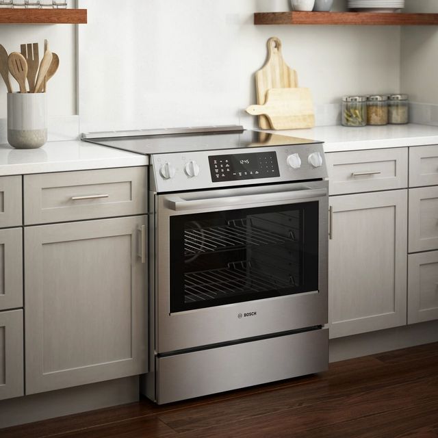 Credit: Bosch Front view of a modern kitchen with a Bosch slide-in electric range