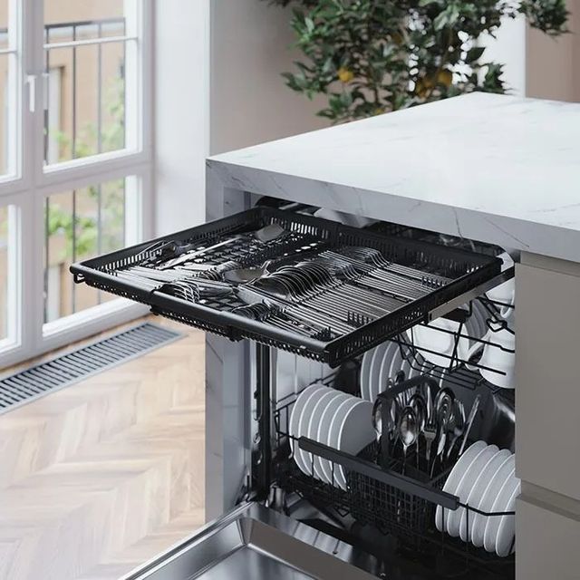 Front view of an opened ASKO third rack dishwasher with the top rack pulled out