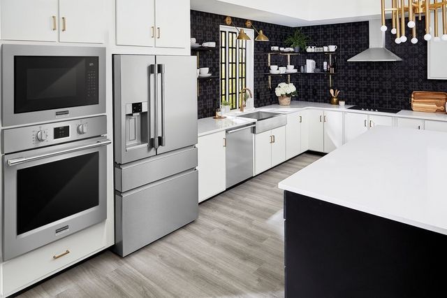 View of a modern kitchen with white cabinetry and stainless steel Frigidaire Professional Series appliances.