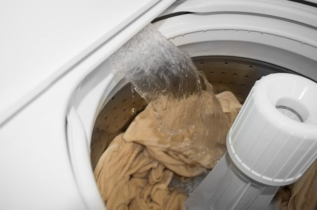 Close view of a Speed Queen top load washer being filled 