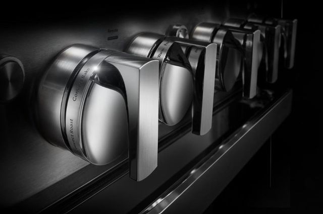Close view of JennAir stove knobs showing the cooking styles