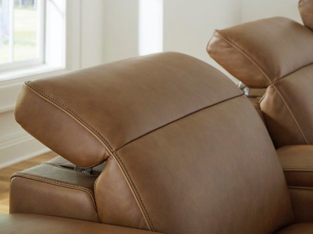 Close view of a leather reclining sectional with the headrests reclined