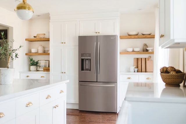 Modern stainless steel refrigerator in a bright kitchen