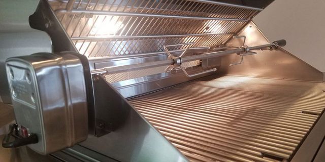 Close view of a XO grill with rotisserie