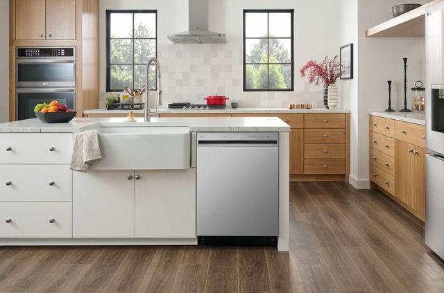 front view of a modern kitchen with a large sink next to a stainless steel LG dishwasher