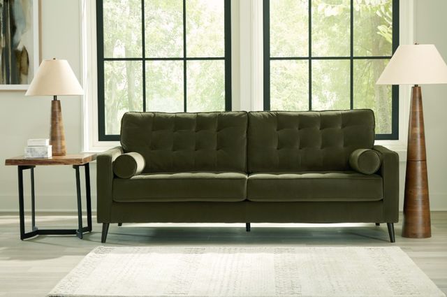 Credit: Ashley Front view of a green mid-century modern sofa with modern decor around