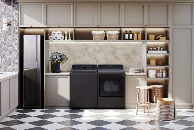 front view of a luxury laundry room with a black top load LG washer and dryer and drying cabinet