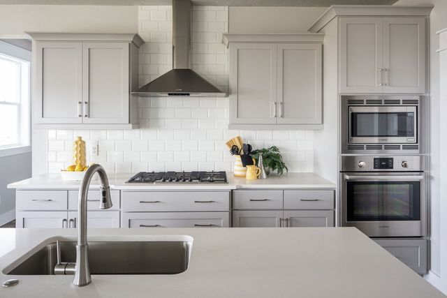 front view of a modern kitchen with a bosch electric wall oven and steam oven