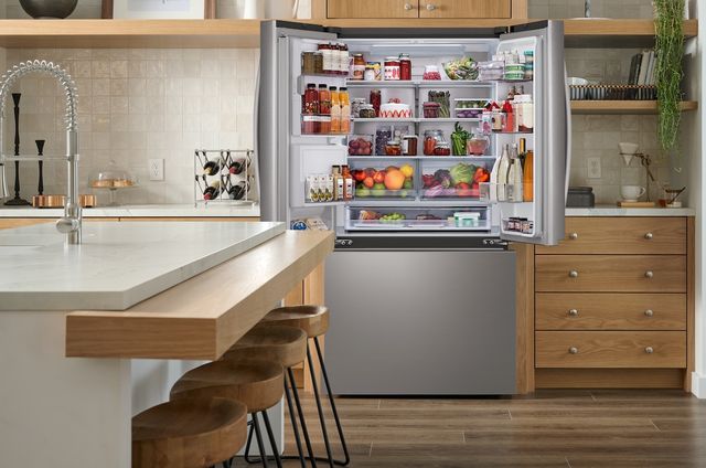 Front view of an opened LG 33” refrigerator opened and stocked Front view of an opened LG 33” refrigerator opened and stocked