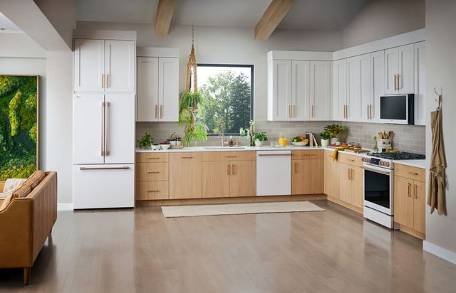 Front view of a modern kitchen with a white LG french door refrigerator