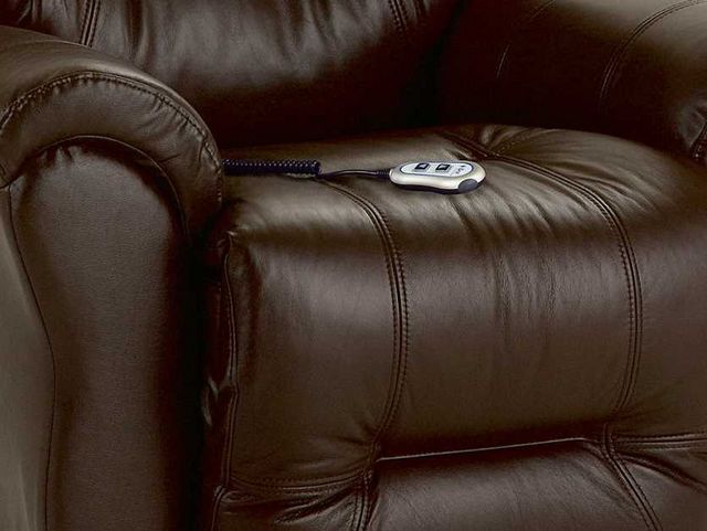 close view of a brown leather recliner with a massage remote sitting on top