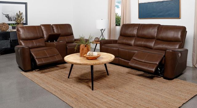 Front view of an industrial style living room with a leather reclining sofa and loveseat set