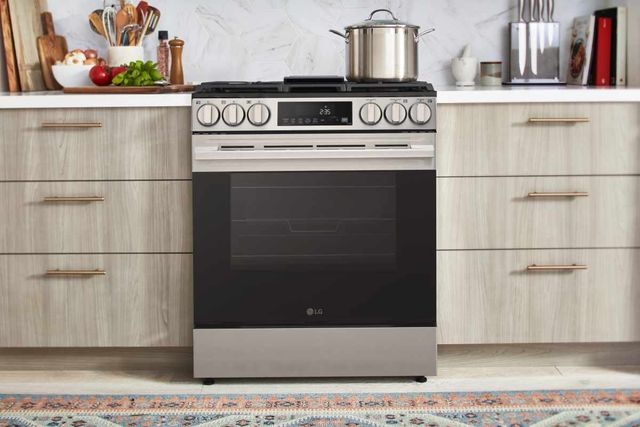 Professional gas range cooking in a modern kitchen