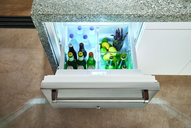view of Perlick refrigerator drawers pulled out from below a counter to show the inside full of drinks